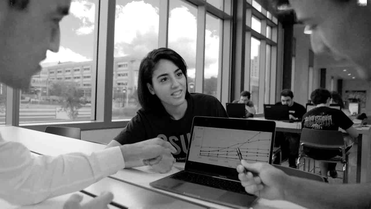 Photo of CSU student working with lab professor